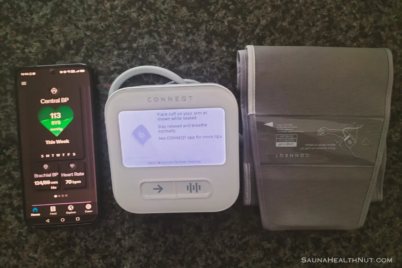 CONNEQT Pulse blood pressure monitor and cuff on a counter with app open on phone
