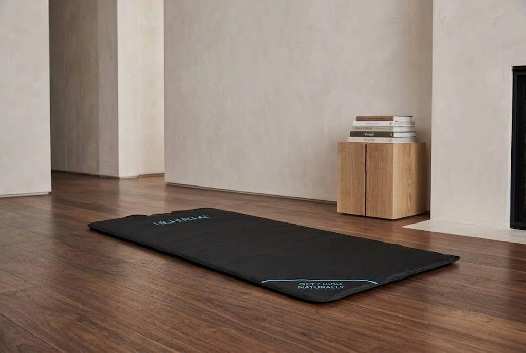 image of HigherDose infrared sauna blanket laying on ground in studio apartment
